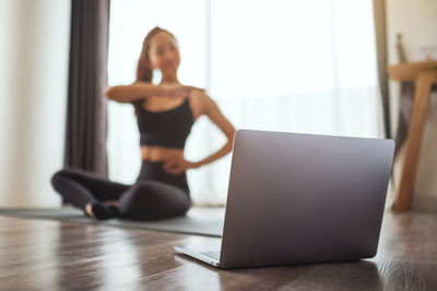 Young woman using laptop at table