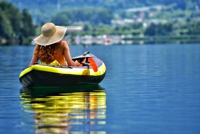 Woman sitting in boat on lake