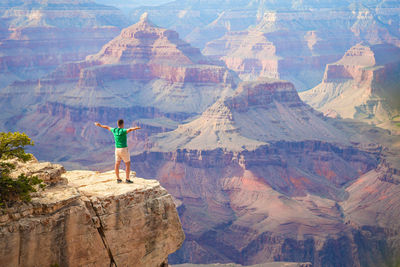 Rear view of man standing on mountain