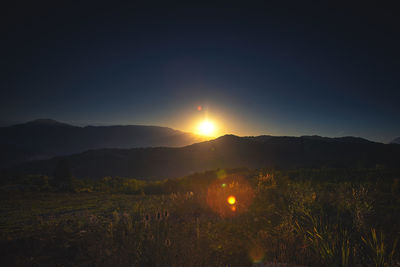 Scenic view of field against sky during sunset