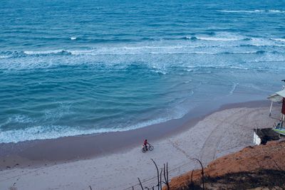 High angle view of man with bicycle at beach