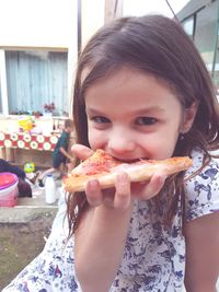 Portrait of cute girl eating food