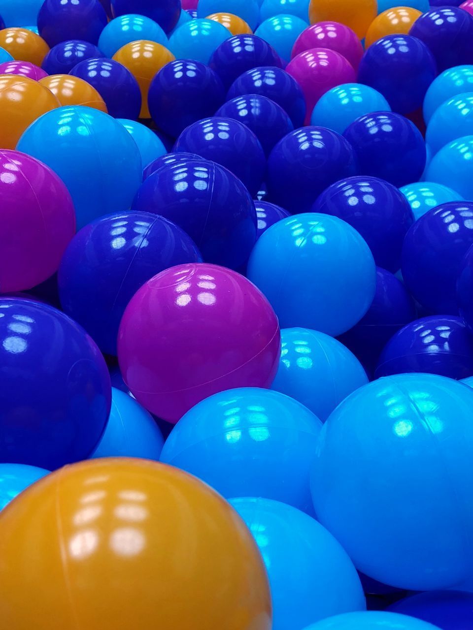 HIGH ANGLE VIEW OF MULTI COLORED BALLOONS