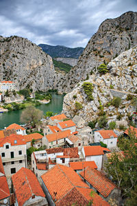 High angle view of townscape and mountains against sky