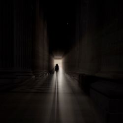 Silhouette of man walking in corridor