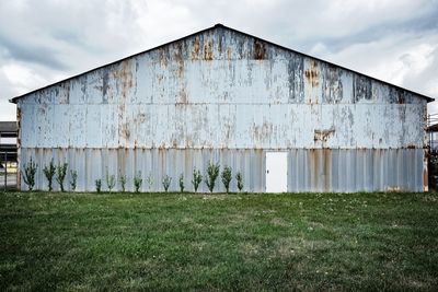 Barn on field against sky