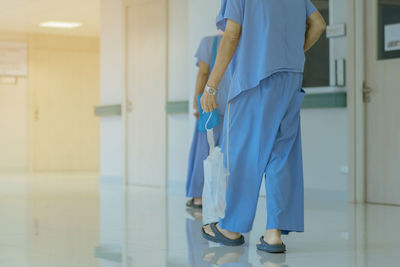 Low section of person standing in corridor of building