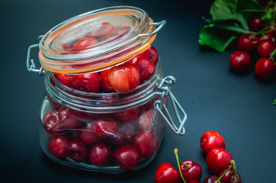 Close-up of strawberries in glass jar on table