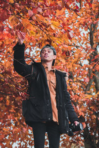 Full length of man standing by tree during autumn