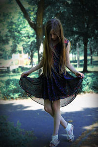 Girl wearing sunglasses against trees