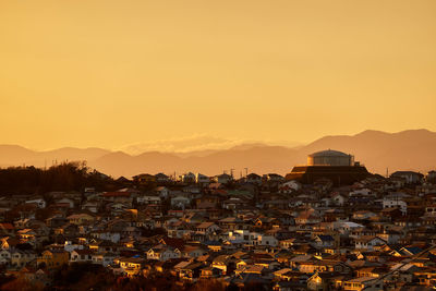 Townscape against sky during sunset