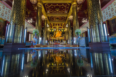 Statue of illuminated building in temple