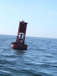 View of ship in sea against clear sky