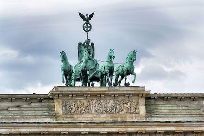 Low angle view of statue against cloudy sky