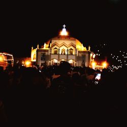 Group of people in illuminated building at night