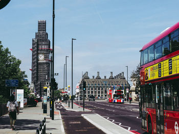 View of city street and buildings against sky