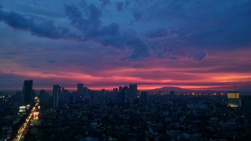 City buildings against sky during sunset