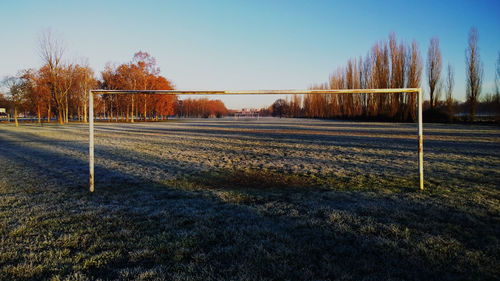 Goal post on field against sky