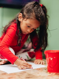 Cute girl drawing at home