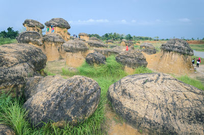 Panoramic view of rocks on field against sky