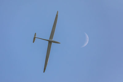 Low angle view of cross against clear blue sky