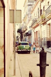 Vehicles on road along buildings