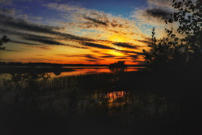 Scenic view of lake against sky during sunset