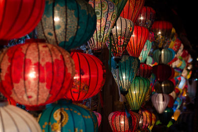 Illuminated lanterns hanging in market at night