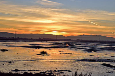 Scenic view of beach against sky during sunset