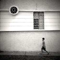 Full length of woman standing on wall