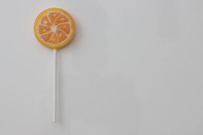 Directly above shot of orange slice against white background