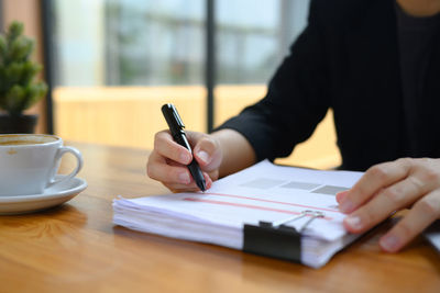 Midsection of man working on table