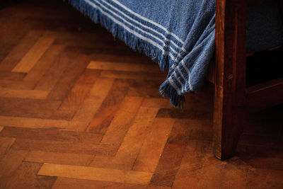 Low section of people on hardwood floor at home