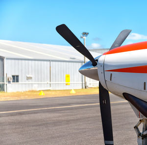 Airplane on airport runway against clear sky