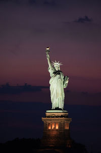 Low angle view of statue against sky during sunset