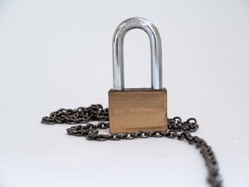 High angle view of padlock on table against white background