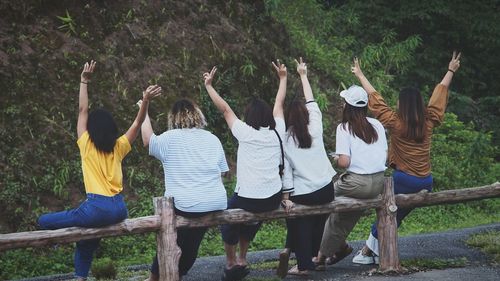 Rear view of people standing in park