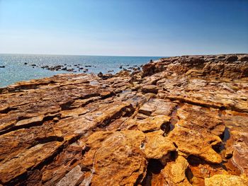 Amazing rocks on beach against clear blue sky