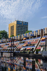 Modern buildings and a classic drawbridge reflect in the water of delftsevaart canal