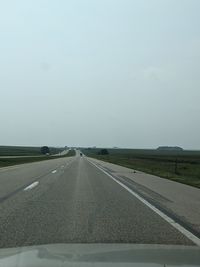 Road against sky seen through car windshield