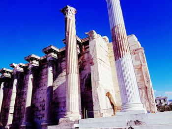 Low angle view of statue against blue sky