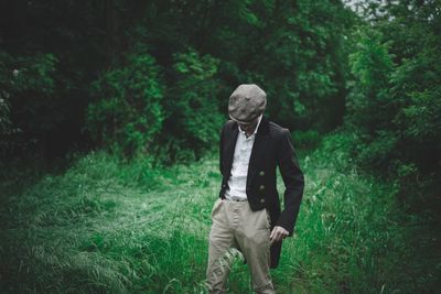 Full length of man standing in forest