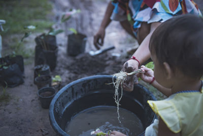 Girl holding root of plant in garden