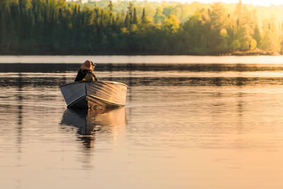 Man in lake against sky