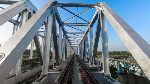 Low angle view of railway bridge against sky