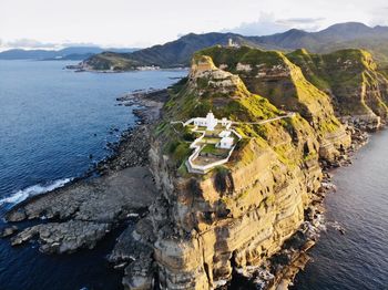 High angle view of rocks on beach against sky