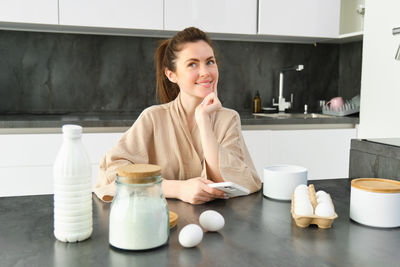 Portrait of young woman having breakfast