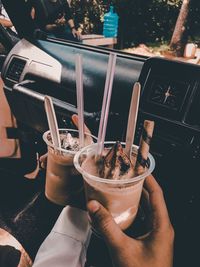 Close-up of hand holding coffee cup