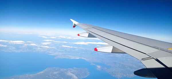 Cropped image of airplane wing against sky