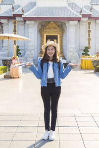 Young asian woman traveler in jeans jacket and backpack traveling in asia